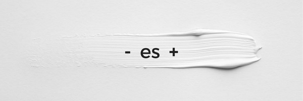 Composición minimalista con una mancha texturizada de pintura blanca sobre fondo claro y el texto '- es +' en el centro, simbolizando visualmente que el minimalismo consiste en elegir lo correcto donde la reducción se convierte en valor añadido